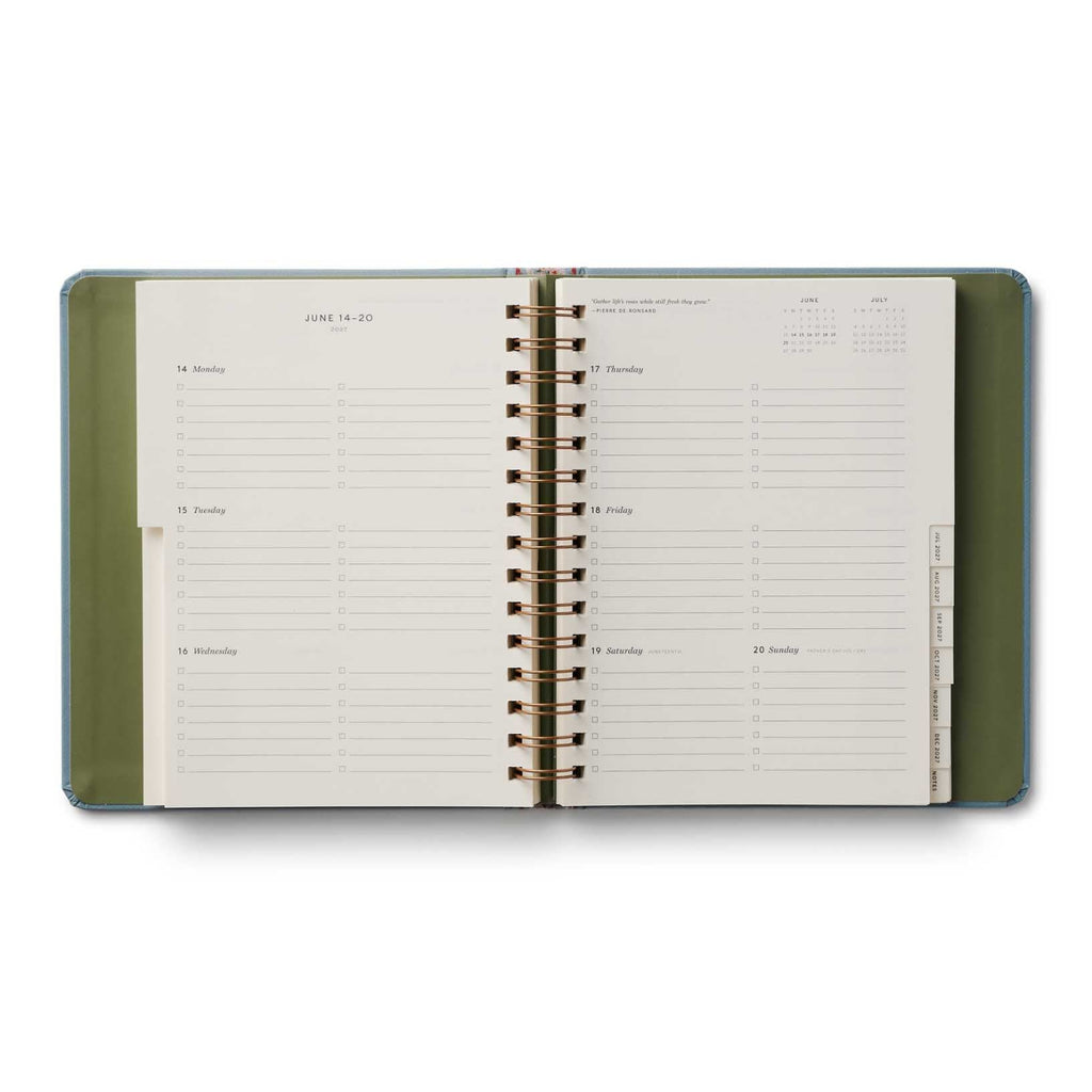 Open planner with green cover on a white background