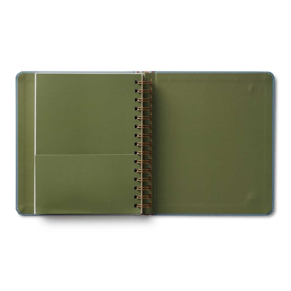 Green notebook with a spiral binding on a white background