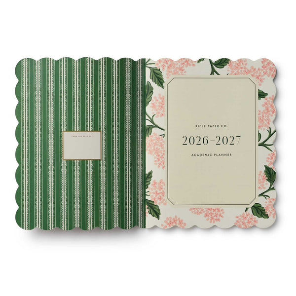 Planner with green striped and floral design on a white background