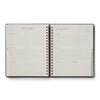 Open planner with daily schedule and notes on a white background