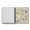Open notebook with decorative stickers on a white background