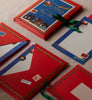 Set of Christmas-themed letter and envelope set with Santa Claus design on a beige surface.