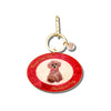 Keychain with a red circular charm featuring an illustration of a dog and text on a white background