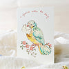 Greeting card with a colorful bird holding an envelope on a white background