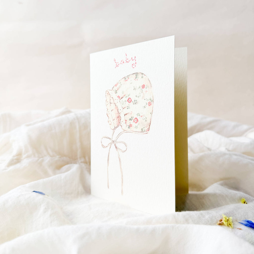 Greeting card with floral balloon design on a white surface