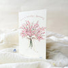 Greeting card with floral design and birthday message on a soft white surface