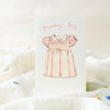 Greeting card with a pink dress illustration and 'Birthday Girl' text on a white background