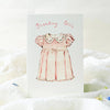 Greeting card with a pink dress illustration and 'Birthday Girl' text on a white background.