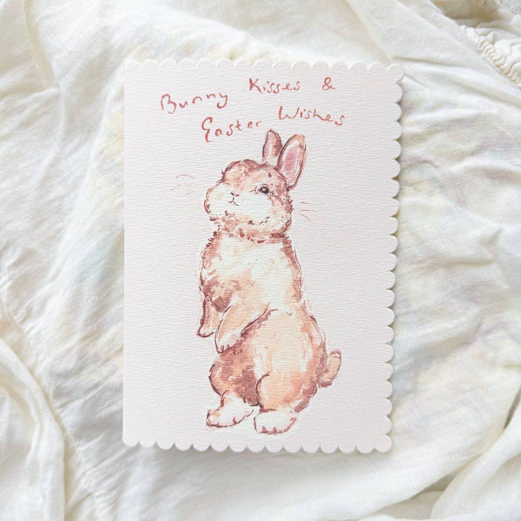 Card with a bunny illustration on a textured white surface
