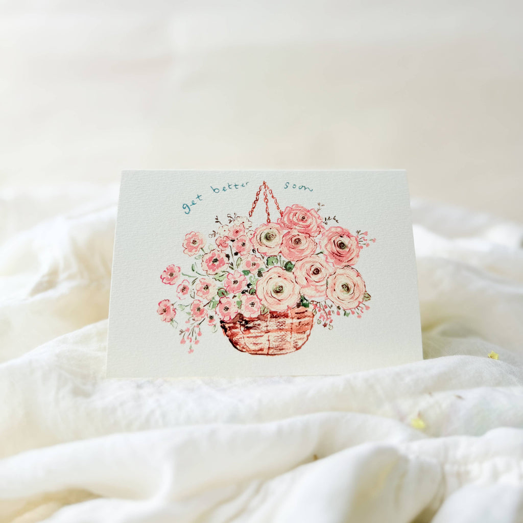 Card with floral design on a white blanket