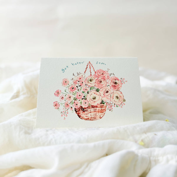 Card with floral design on a white blanket