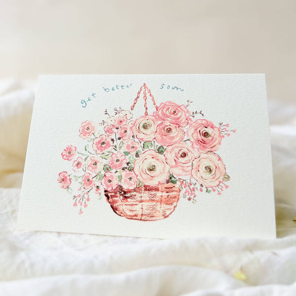 Card with a floral design and text on a soft fabric background