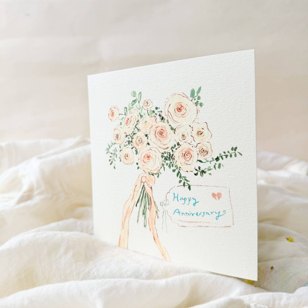 Greeting card with floral design and 'Happy Anniversary' text on a soft white background