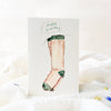 Greeting card with a sock illustration and 'Happy Birthday' text on a white background.