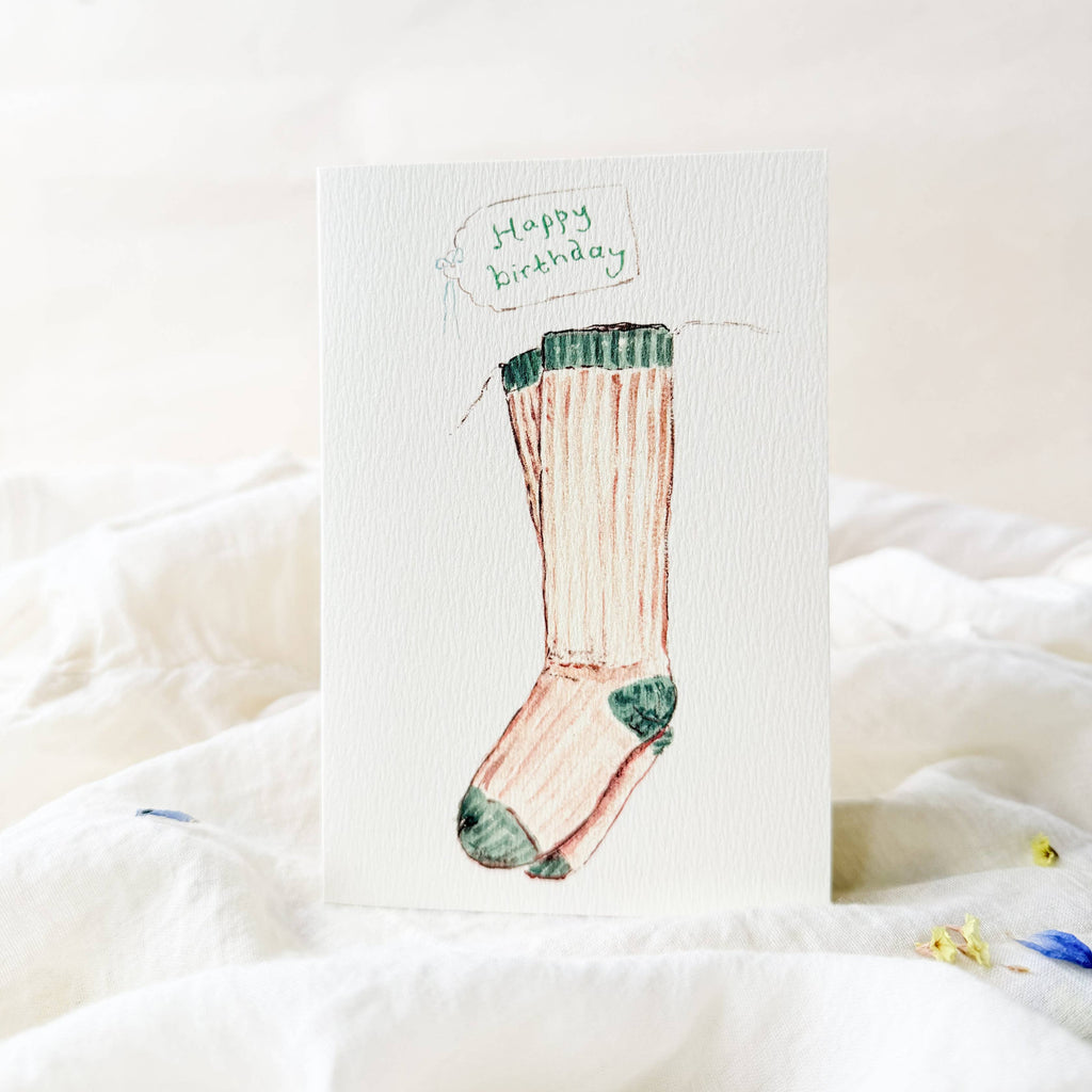 Greeting card with a sock design and 'Happy birthday' text on a white background