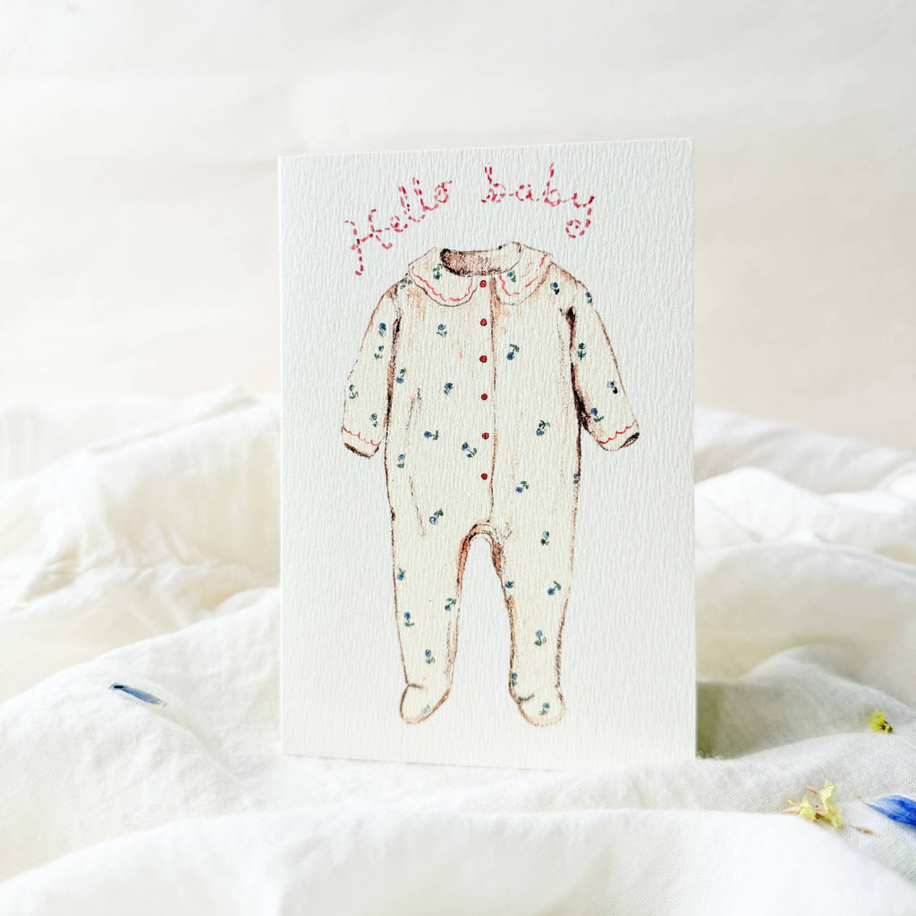 Card with a baby onesie illustration and 'Hello Baby' text on a white background