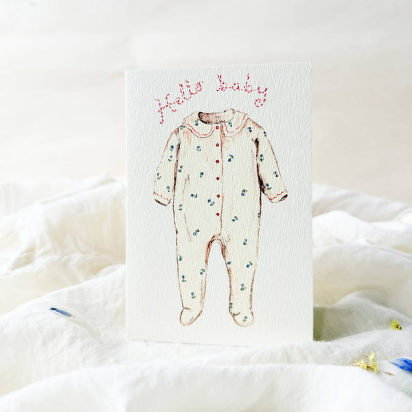Card with a baby onesie illustration and 'Hello Baby' text on a white background