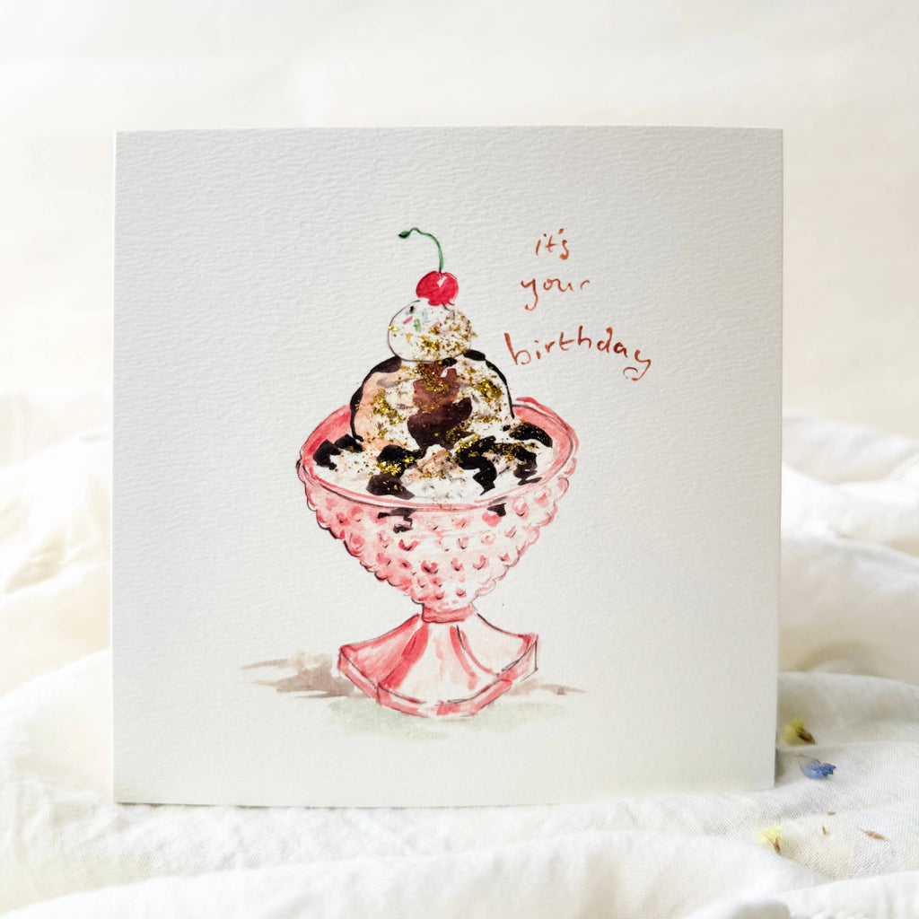 Greeting card with a pink glass dish holding ice cream and a cherry, with 'Happy Birthday' text.