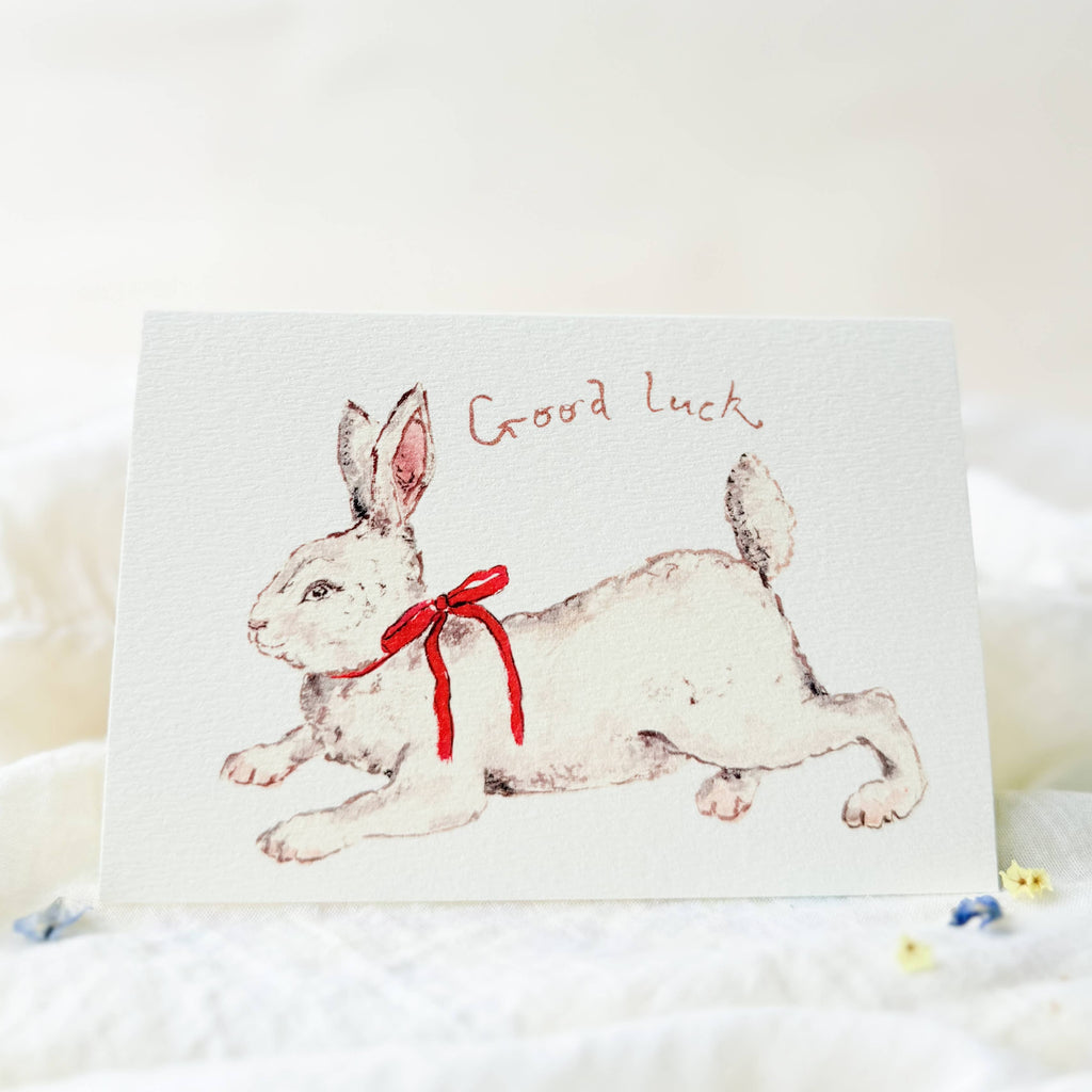 Card with a rabbit illustration and 'Good luck' text on a white background