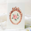Decorative card with a pink rose and floral frame on a white background