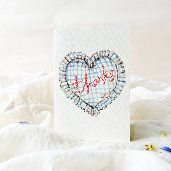 Heart-shaped card with 'thanks' text on a white background