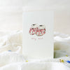 Card with floral baby booties illustration and 'tiny feet' text on a white background