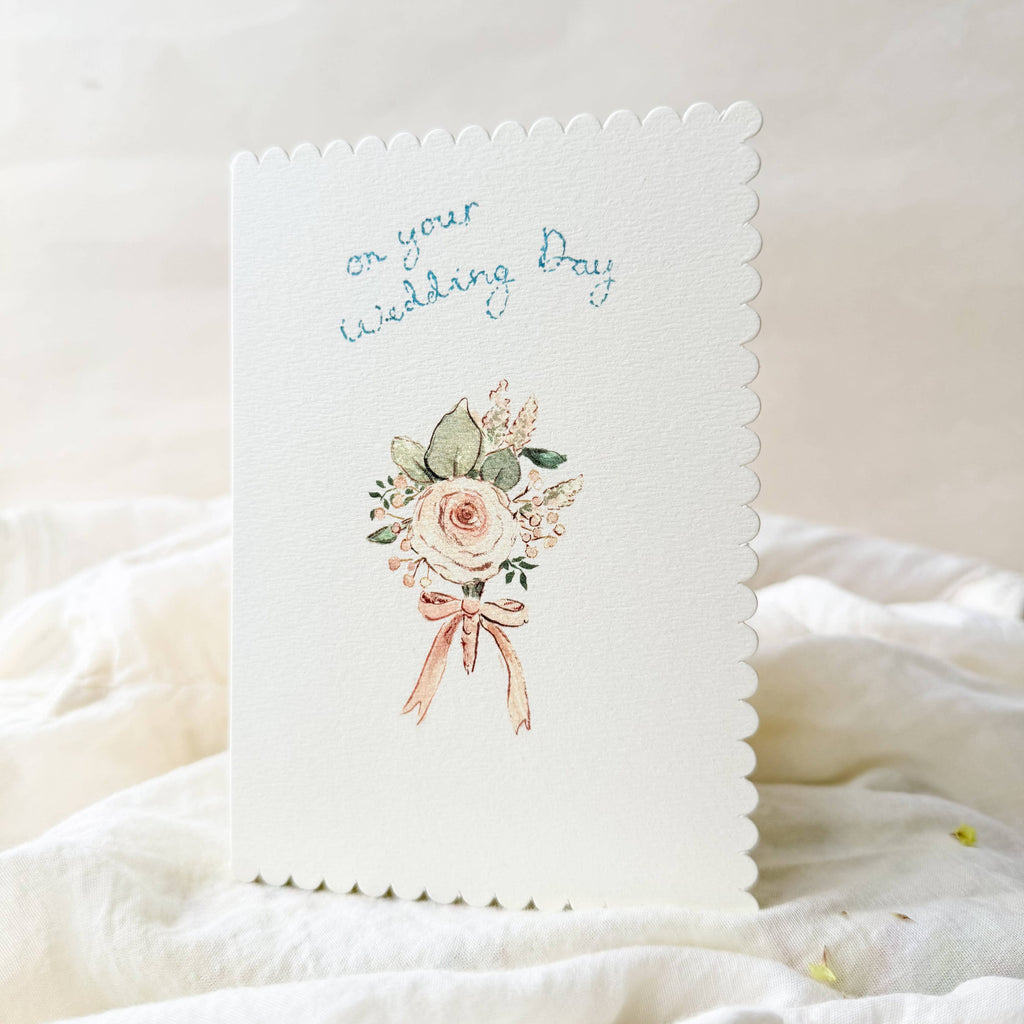Card with floral design and text on a white fabric background