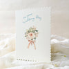 Card with floral design and text on a white fabric background