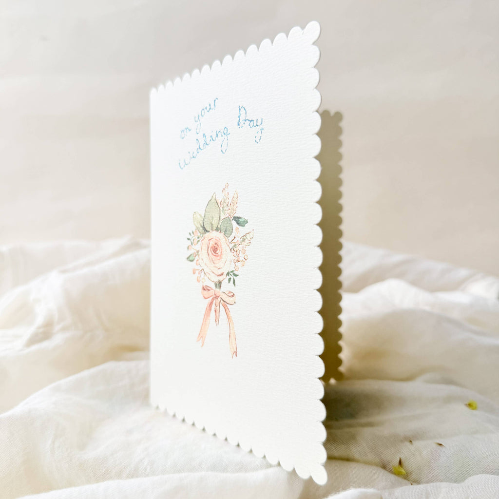 Greeting card with floral design and text on a white fabric background