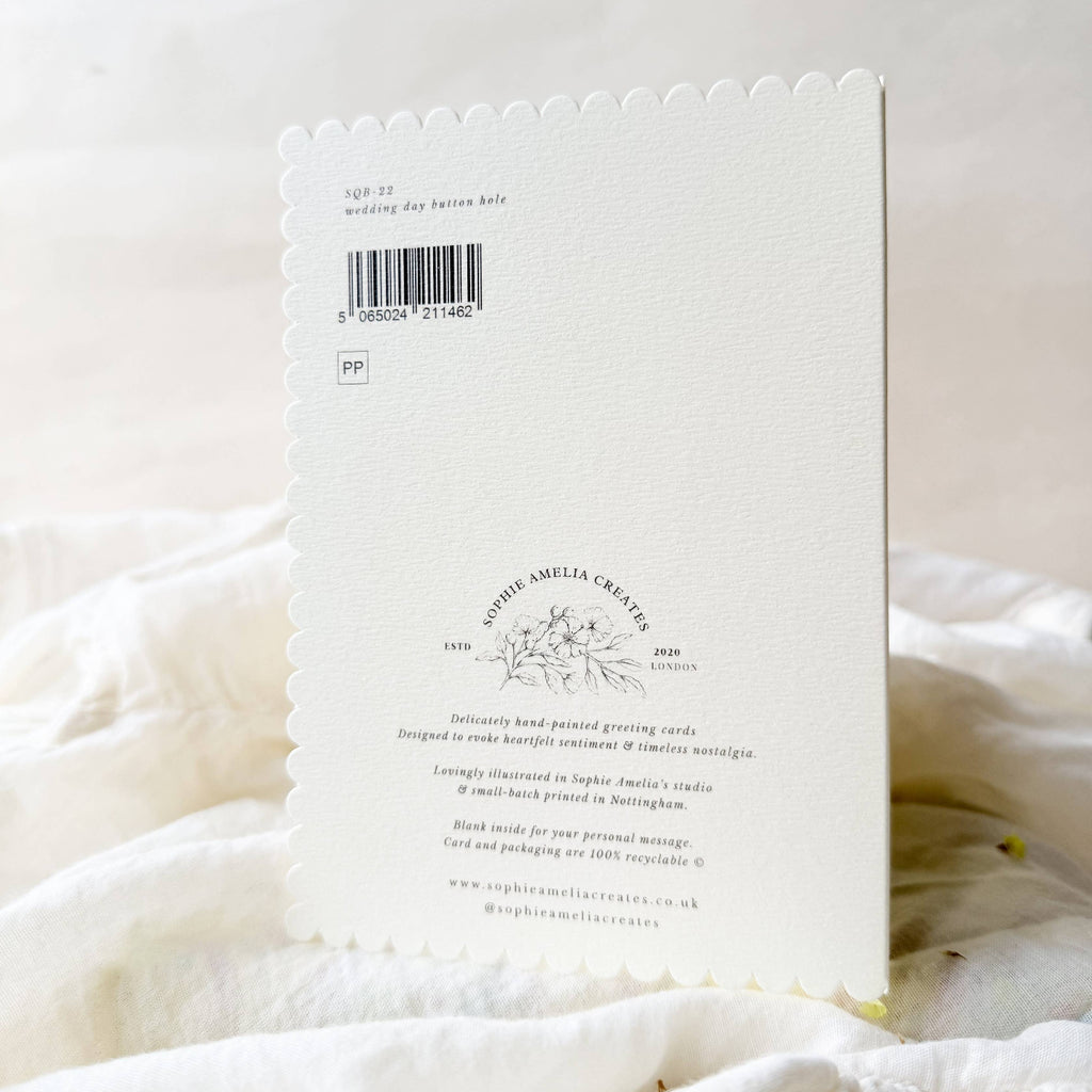 White product packaging with text and a barcode on a white fabric background