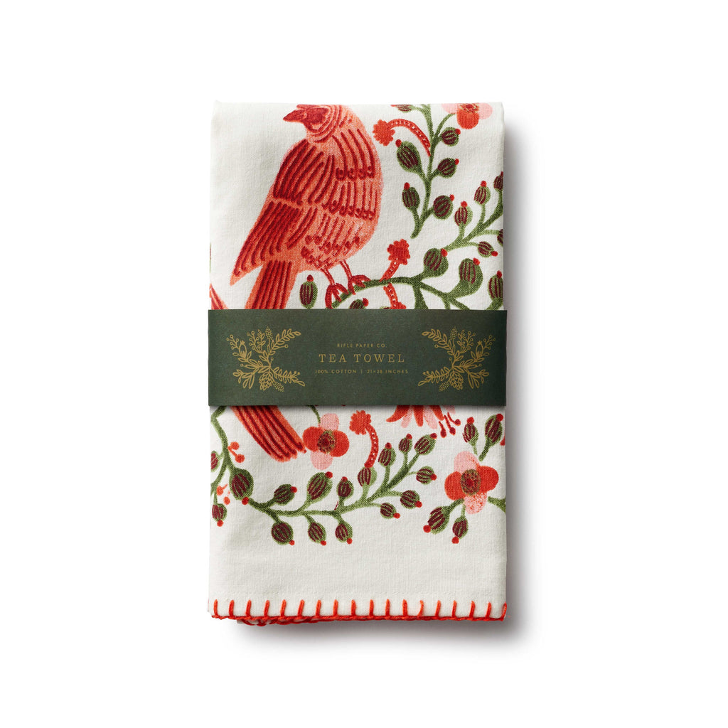 Packaged tea towel with red bird and floral design on a white background