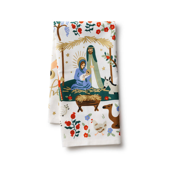 Folded towel with nativity scene design on a white background