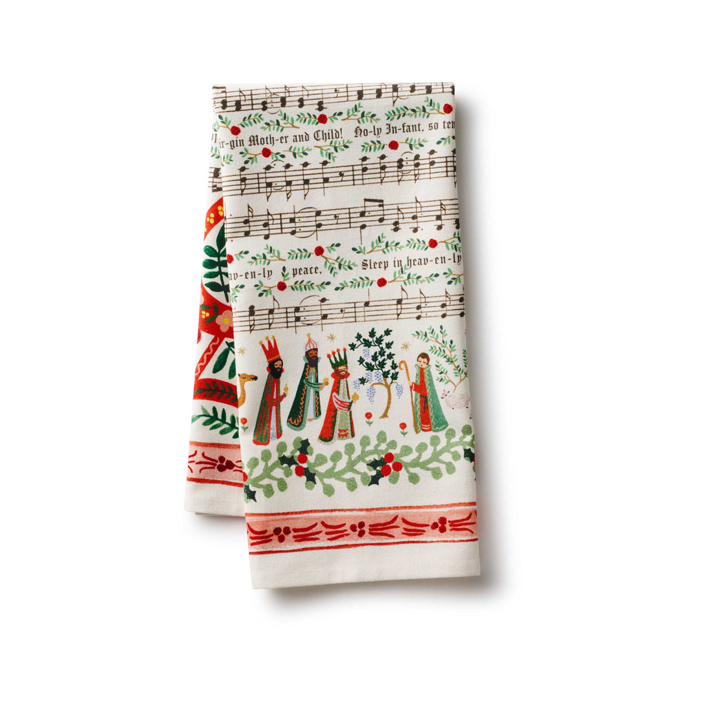 Set of two Christmas-themed kitchen towels with musical notes and nativity scene design on a white background.
