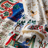 Decorative fabric with Christmas-themed designs featuring nativity scenes and festive elements.