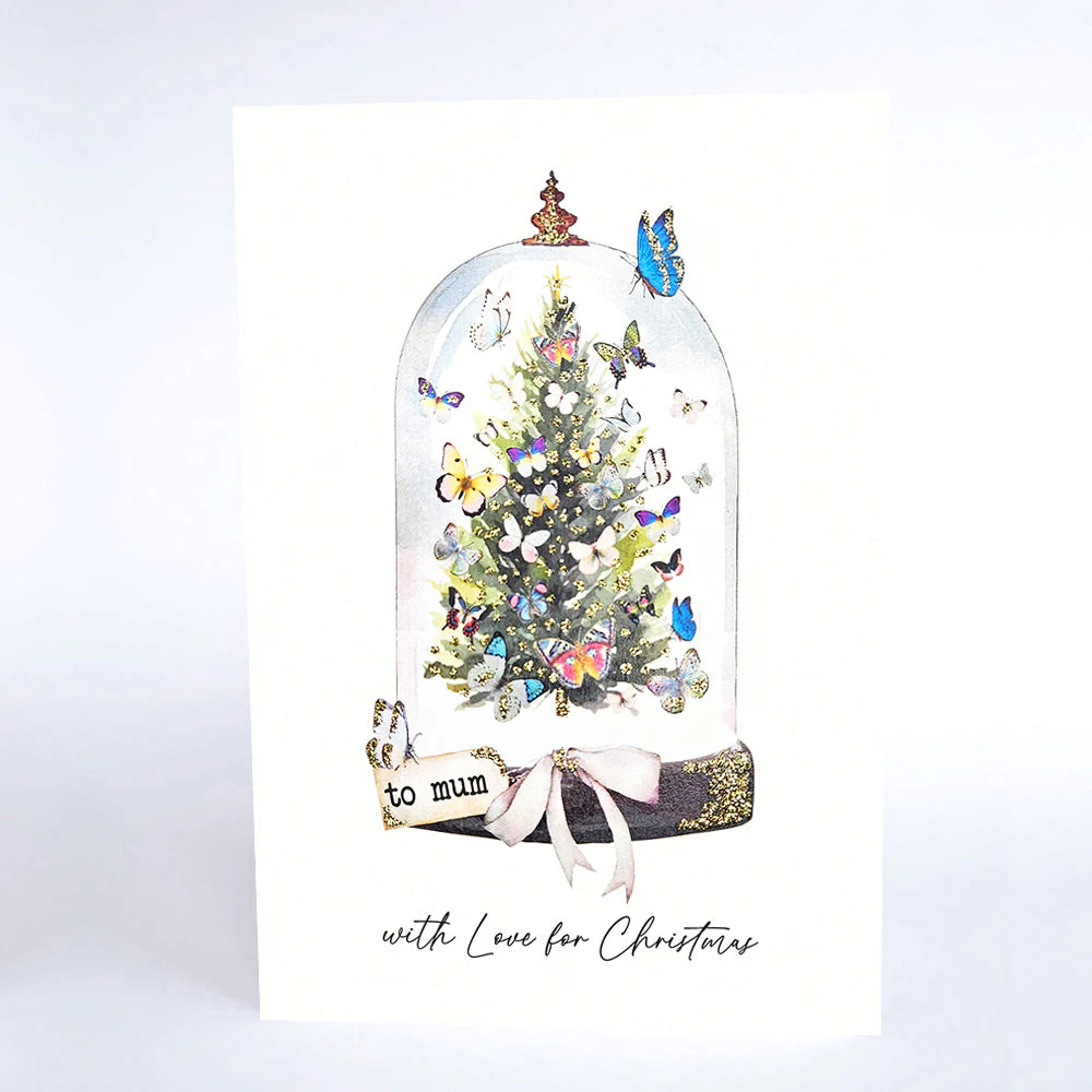 Christmas card with a decorated tree under a glass dome, featuring butterflies and the text 'to mum with Love for Christmas'.