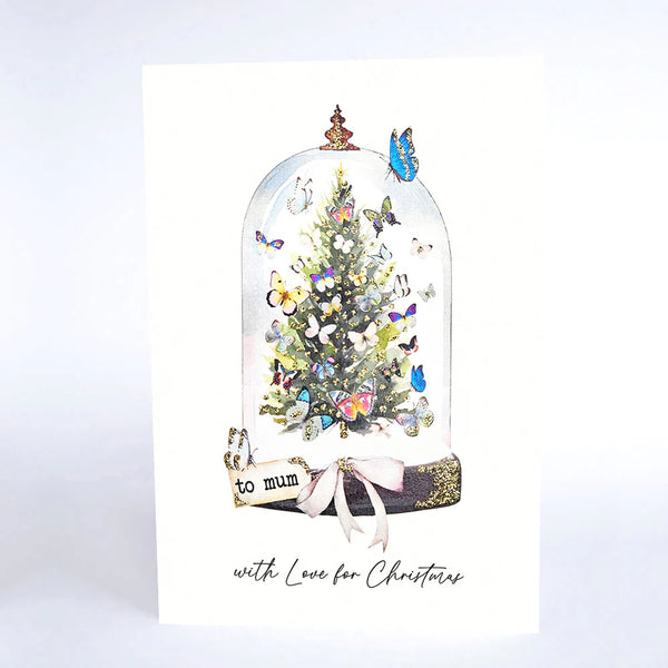 Christmas card with a decorated tree under a glass dome, featuring butterflies and the text 'to mum with Love for Christmas'.