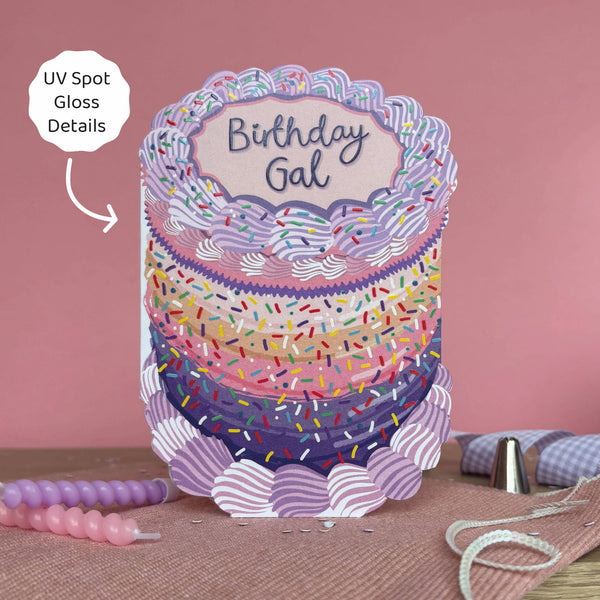 Decorative birthday cake card with colorful sprinkles and 'Birthday Gal' text on a pink background.