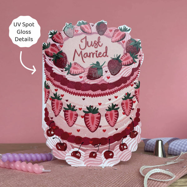 Card with a cake design featuring strawberries and 'Just Married' text on a pink background.