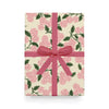 Gift box with floral pattern and pink ribbon on a white background