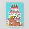 Cartoon birthday cake with candles and a bear on a blue background