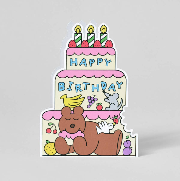 Sticker of a birthday cake with candles and a bear holding a cake on a gray background