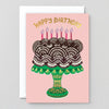 Birthday card with a cake illustration and 'Happy Birthday' text on a pink background