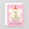 Birthday card with a cartoon dog and cake on a pink background