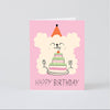 Birthday card with a cartoon dog and cake on a pink background