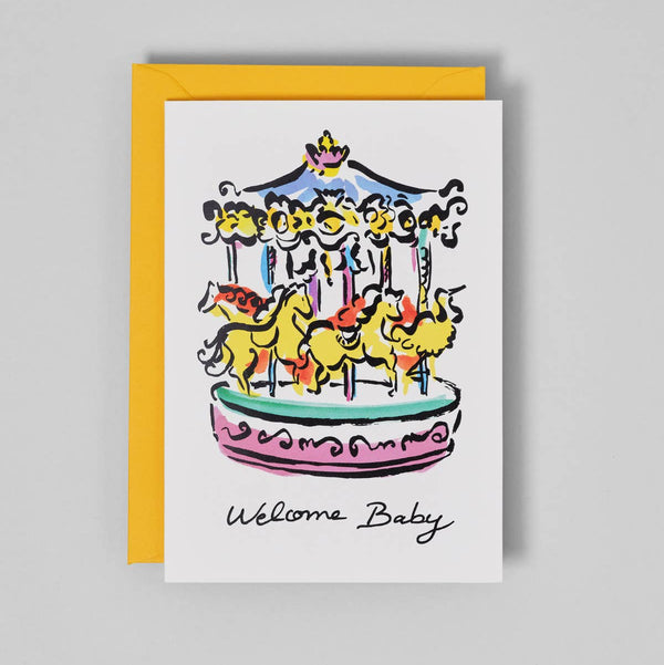 Greeting card with a colorful carousel illustration and 'Welcome Baby' text on a gray background
