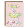 Greeting card with three yellow cocktail glasses and pink ribbons on a pink background, featuring the text 'Happy Wedding'.