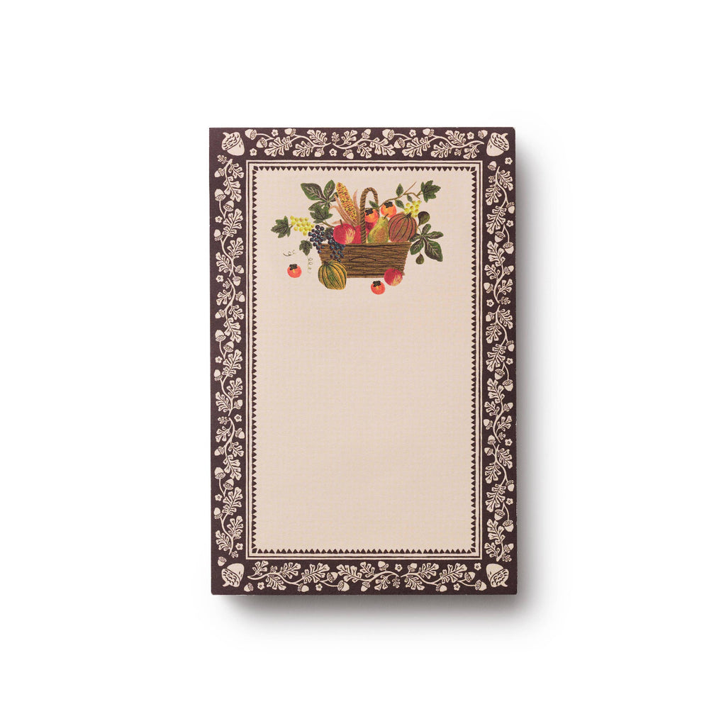 Rectangular notepad with decorative border and central illustration of a basket of fruits on a white background