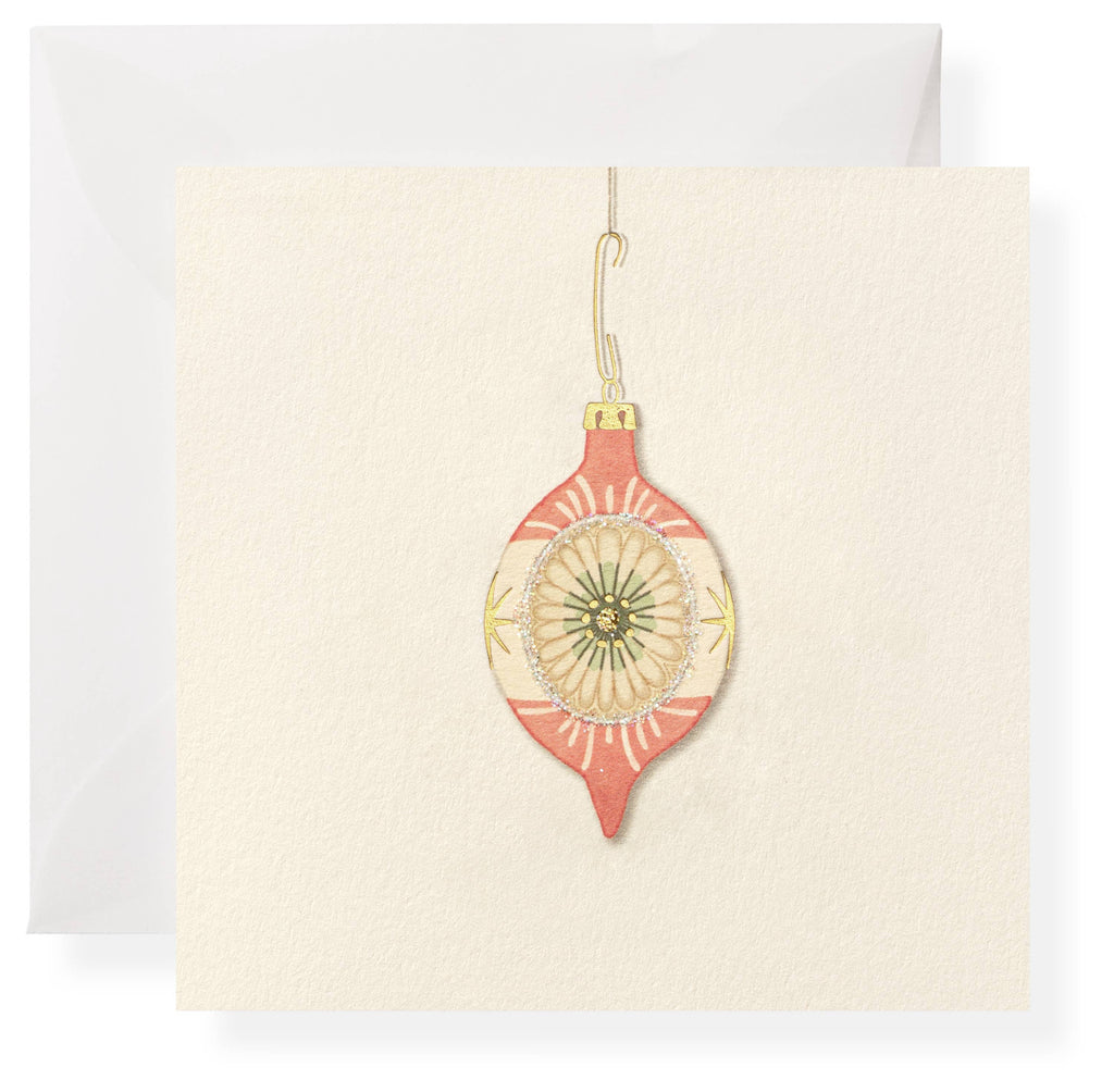 Card with a pink Christmas ornament on a white background
