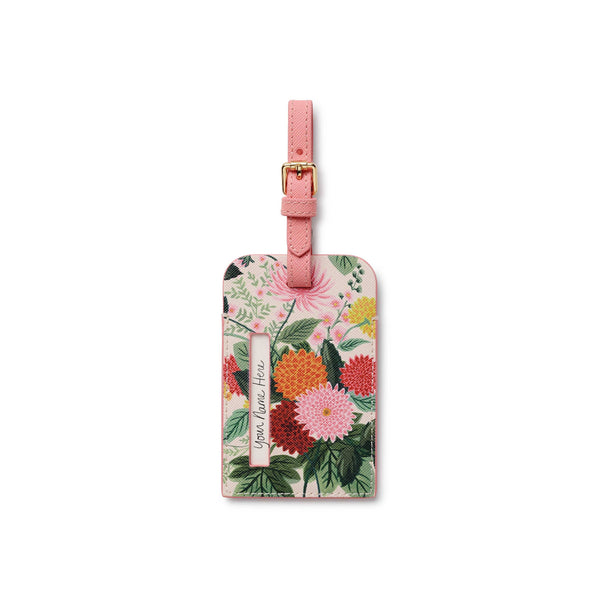 Floral luggage tag with pink strap on a white background