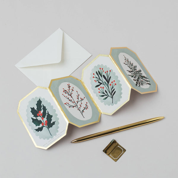 Hexagonal cards with floral designs on a light gray background with a pen and envelope.